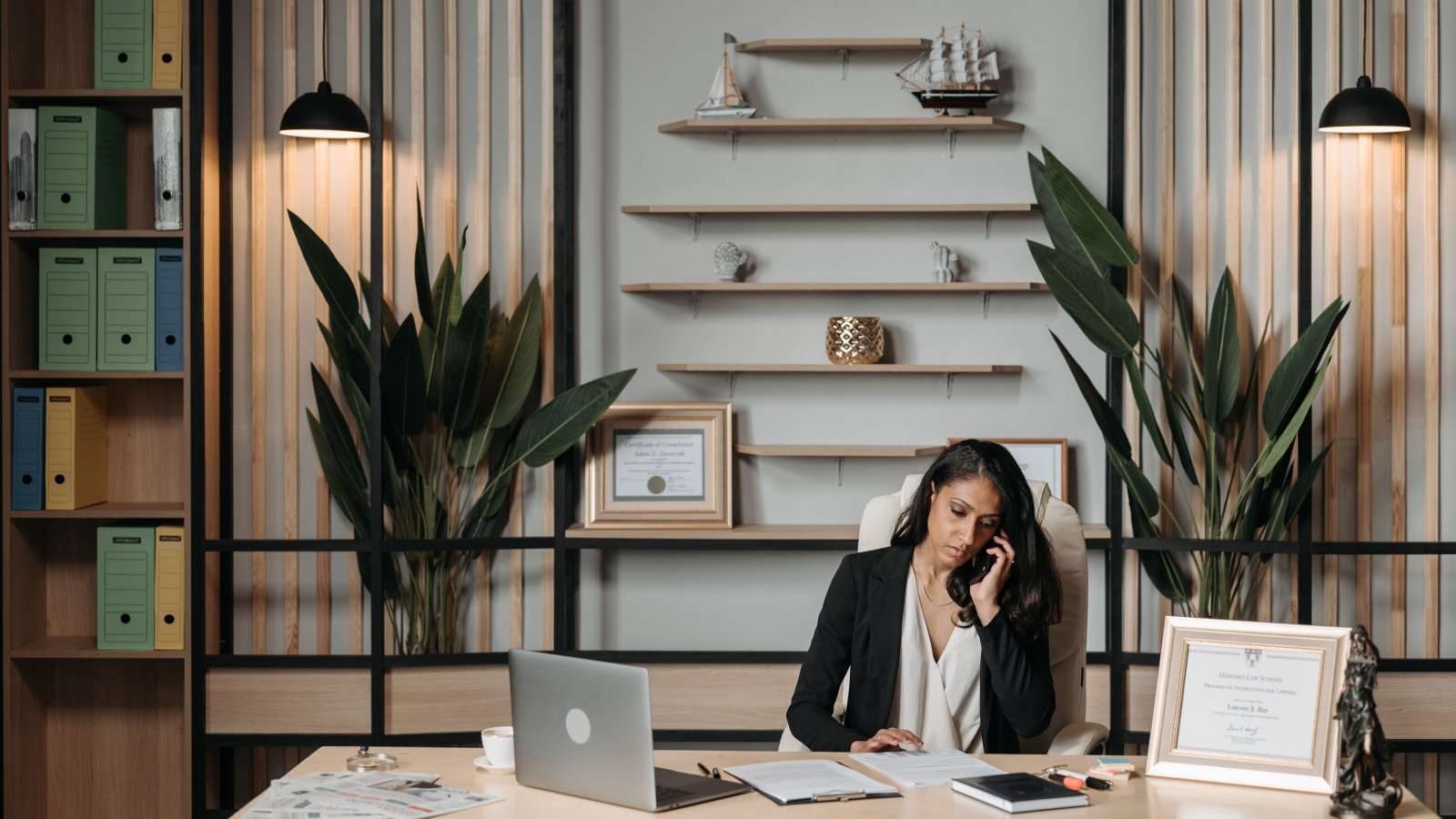 Businesswoman working at her desk on phone in a professional office environment